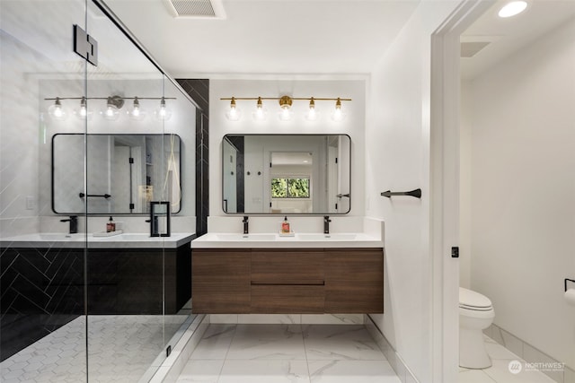 bathroom with toilet, an enclosed shower, and vanity