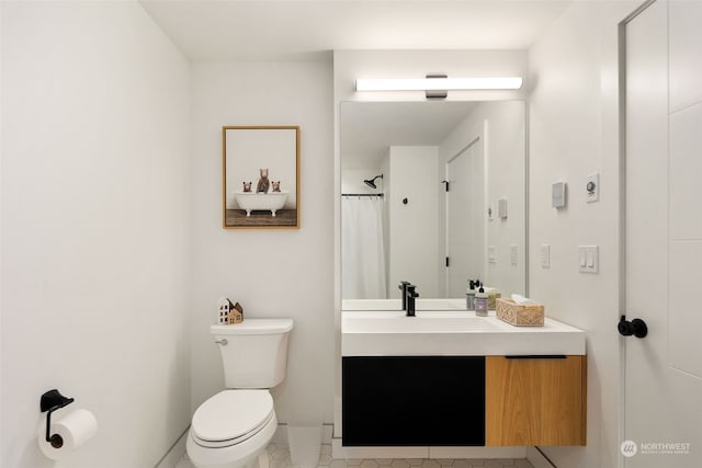 bathroom with toilet, tile patterned flooring, and vanity