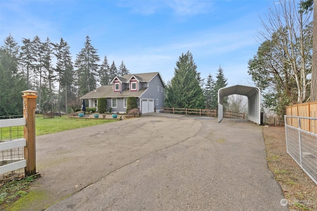 view of front facade with a carport, a garage, and a front lawn