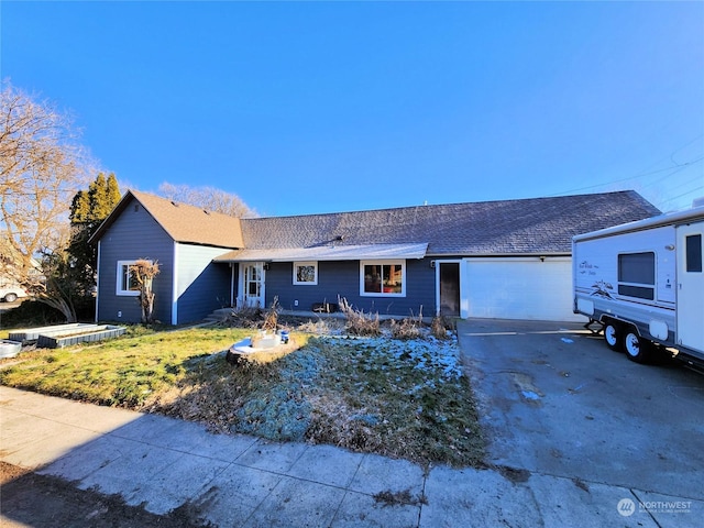 ranch-style house with a garage and a front yard