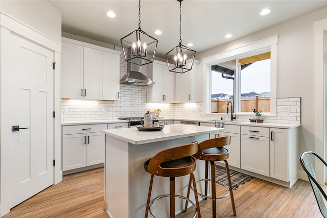 5986 Ranch Loop, Ferndale, WA 98248 - kitchen featuring a sink, white cabinetry, light wood finished floors, a kitchen island, and recessed lighting