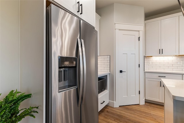 5986 Ranch Loop, Ferndale, WA 98248 - kitchen featuring stainless steel fridge with ice dispenser, light countertops, decorative backsplash, and light wood-style floors