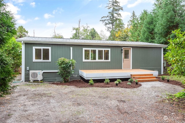 manufactured / mobile home featuring ac unit and a wooden deck