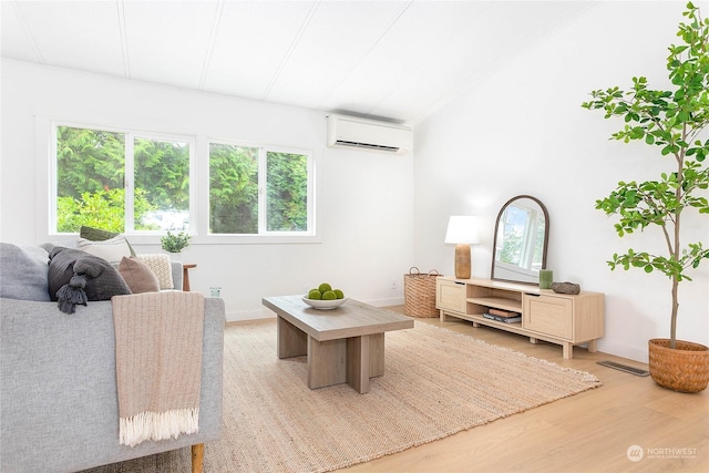 living room featuring light hardwood / wood-style floors and a wall mounted air conditioner