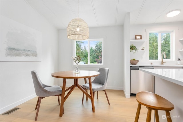 dining area featuring sink and light hardwood / wood-style flooring