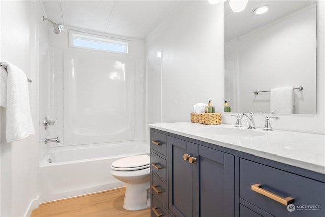 full bathroom featuring toilet, vanity,  shower combination, hardwood / wood-style flooring, and ornamental molding