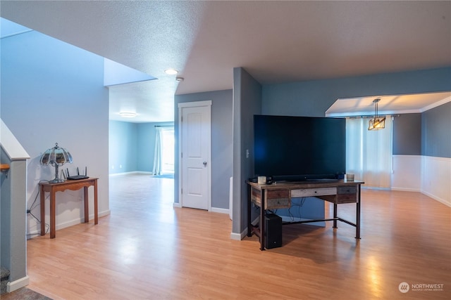 living room featuring light hardwood / wood-style floors and a textured ceiling