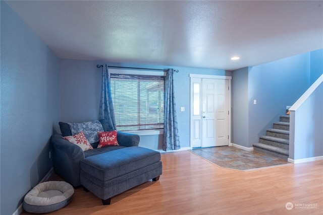 living area with a textured ceiling and wood-type flooring