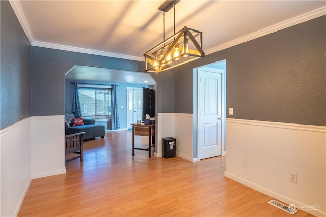 dining space featuring hardwood / wood-style floors and crown molding