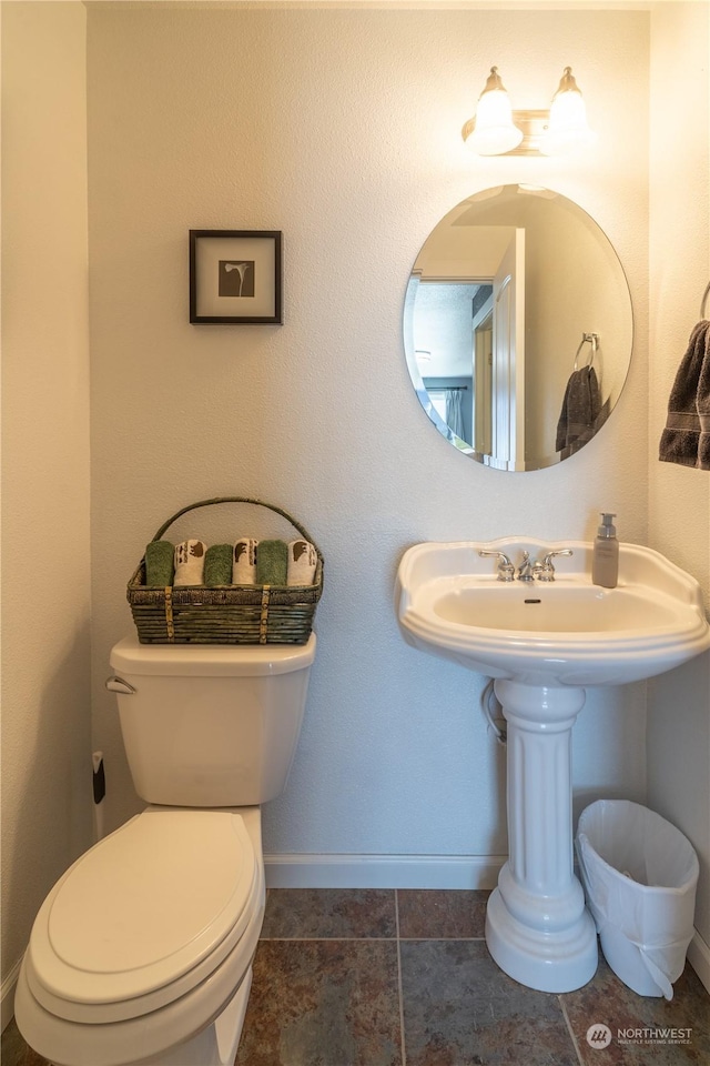 bathroom featuring toilet and tile patterned floors