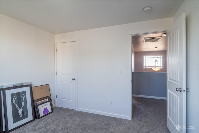 unfurnished bedroom featuring dark colored carpet