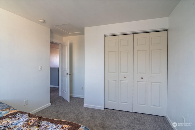 unfurnished bedroom featuring a closet and dark carpet