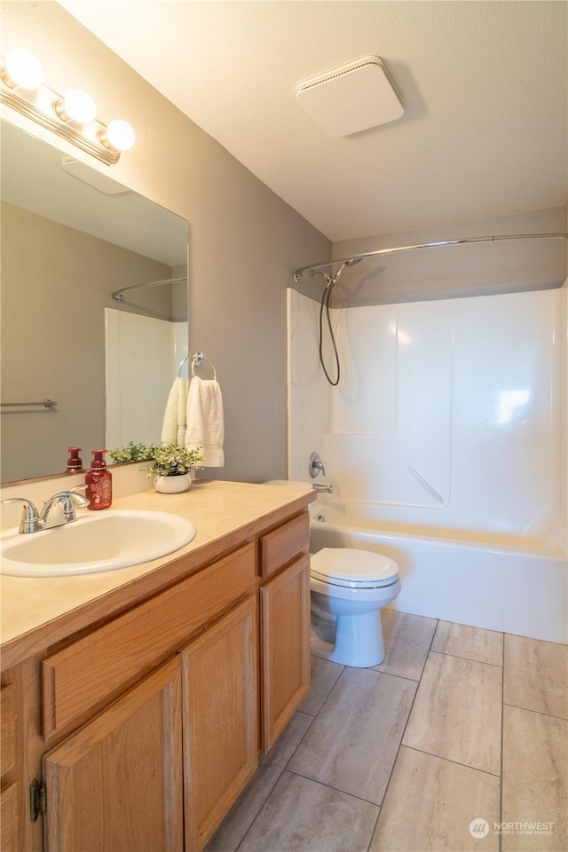 full bathroom featuring  shower combination, toilet, and vanity