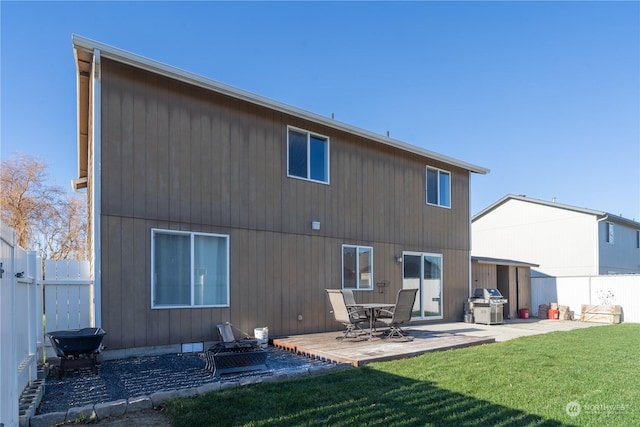 back of house featuring a lawn and a patio