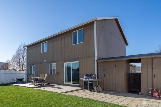 back of house with a patio area and a yard