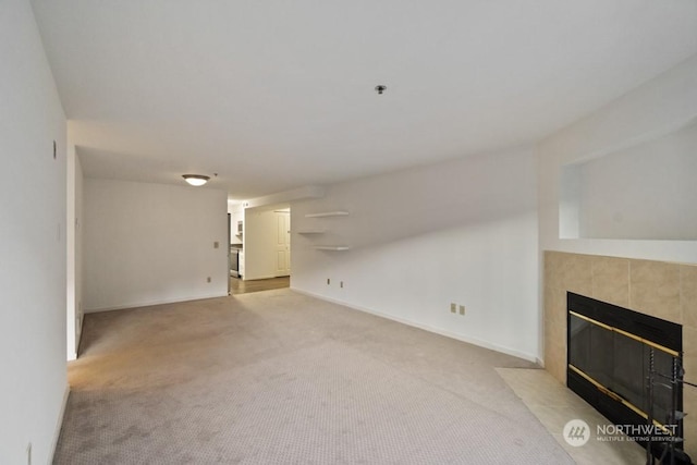 unfurnished living room with light colored carpet and a fireplace