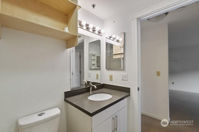 bathroom featuring vanity and toilet