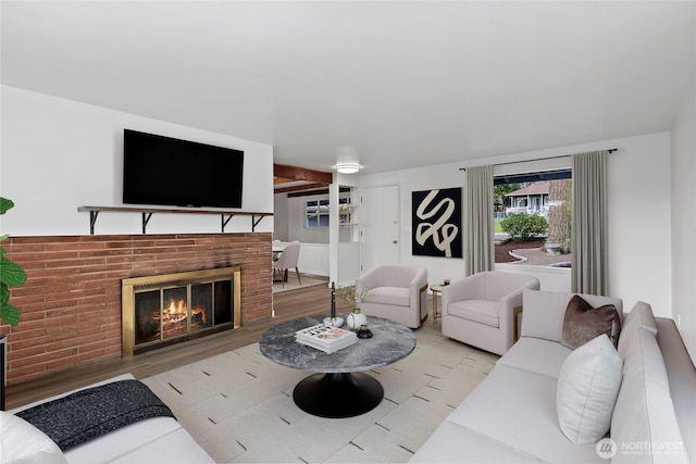 living area with a fireplace and wood finished floors