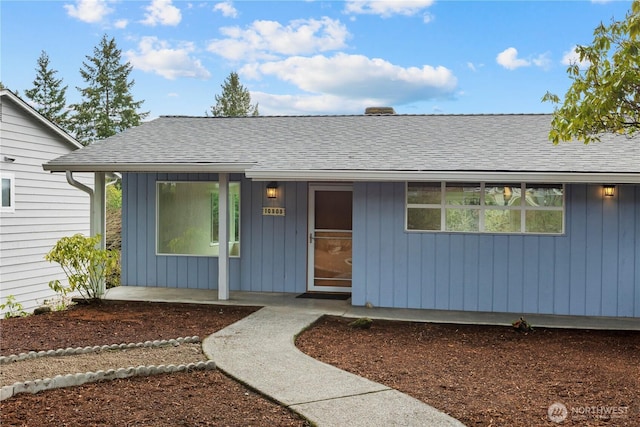 view of front of house with board and batten siding and roof with shingles