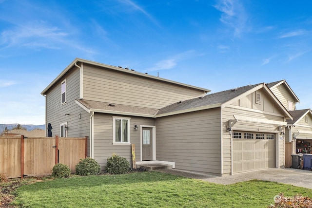 view of front of house with a garage and a front lawn