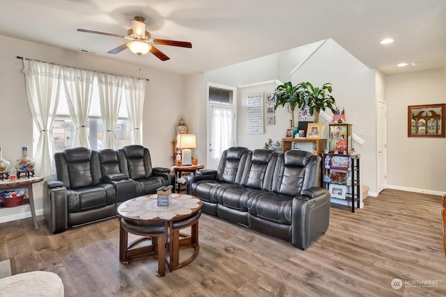 living room featuring ceiling fan and hardwood / wood-style flooring