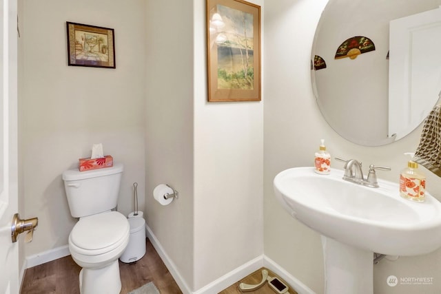 bathroom featuring sink, hardwood / wood-style floors, and toilet