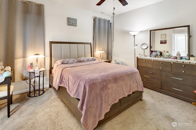 bedroom with ceiling fan and light carpet