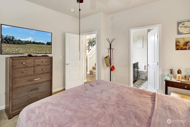 bedroom with ceiling fan and ensuite bath