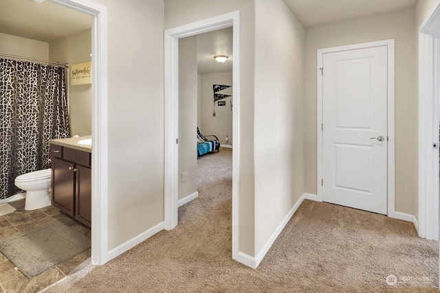 bathroom with toilet, vanity, and a shower with curtain