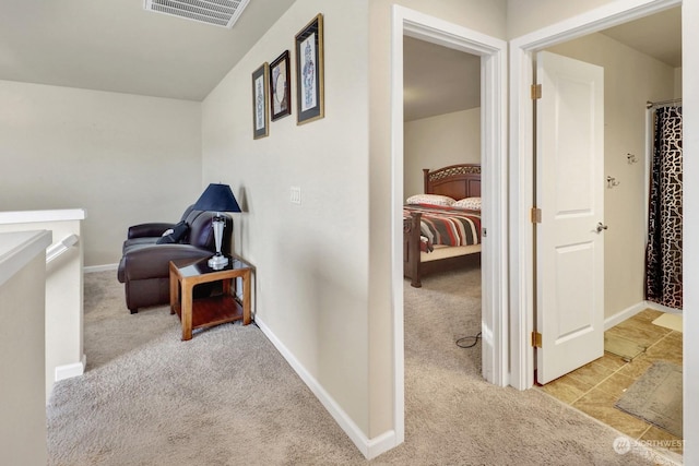 corridor featuring light colored carpet