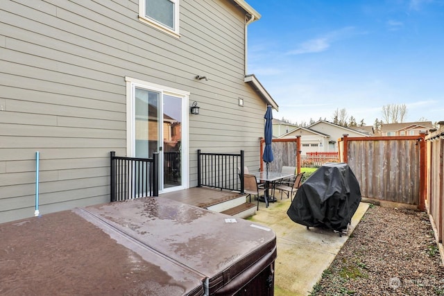 view of patio featuring a hot tub and a grill