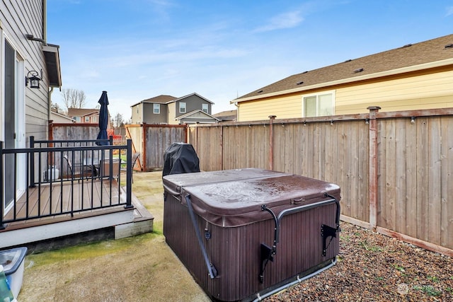 view of yard with a hot tub and a deck