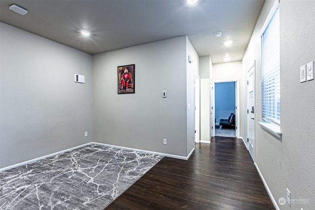 unfurnished room featuring dark wood-type flooring