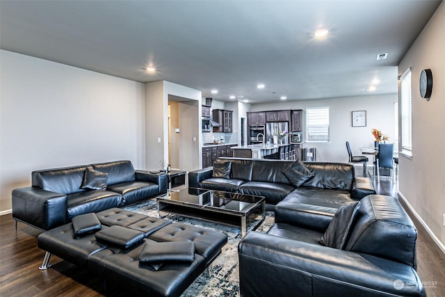 living room with dark hardwood / wood-style flooring