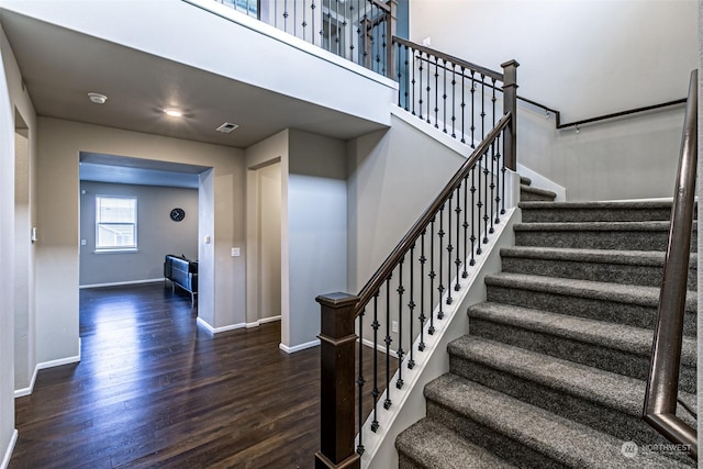 staircase with hardwood / wood-style flooring