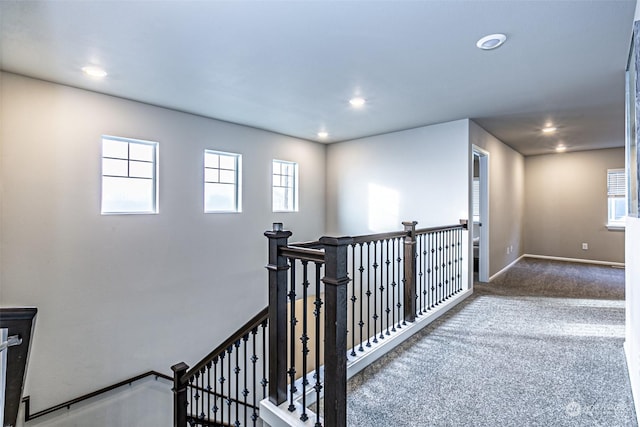 hall featuring carpet flooring