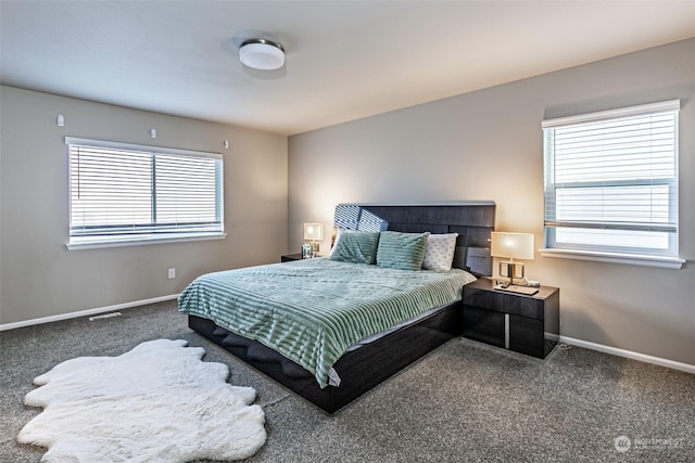 bedroom with dark colored carpet