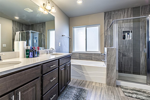 bathroom featuring vanity and shower with separate bathtub