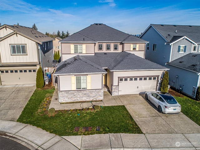 view of front of home featuring a garage and a front yard