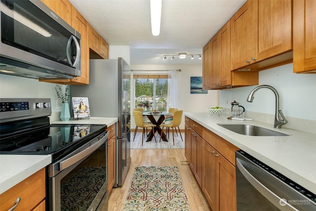 kitchen featuring sink, stainless steel appliances, and light hardwood / wood-style flooring