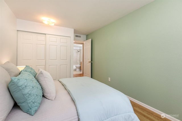 bedroom with hardwood / wood-style floors and a closet