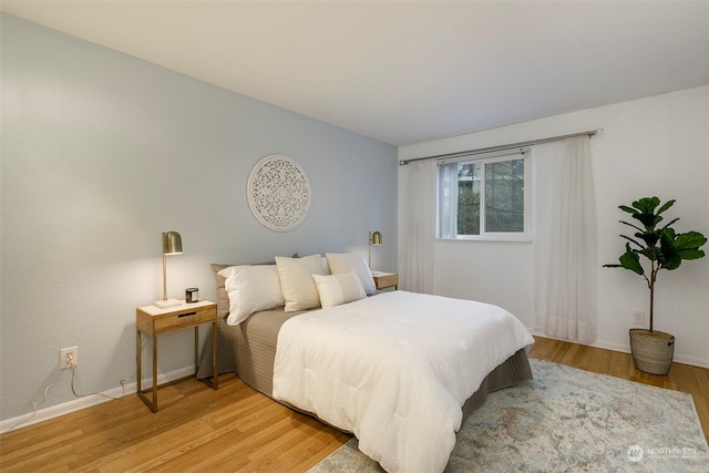 bedroom with hardwood / wood-style floors