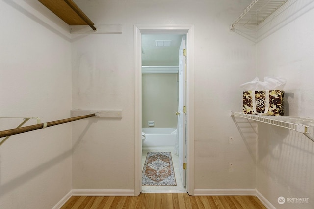 walk in closet featuring hardwood / wood-style floors