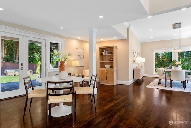 dining space featuring decorative columns, dark hardwood / wood-style flooring, and french doors