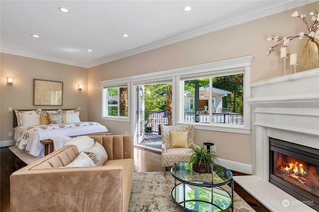 bedroom featuring crown molding, hardwood / wood-style flooring, and access to outside