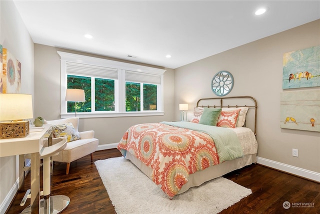 bedroom with dark hardwood / wood-style flooring