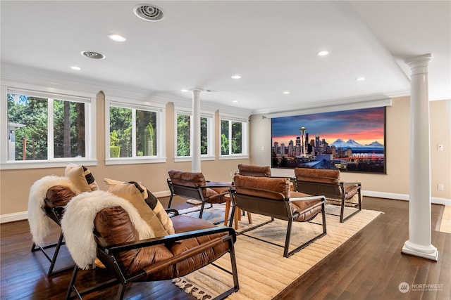 interior space with crown molding, dark hardwood / wood-style flooring, and ornate columns