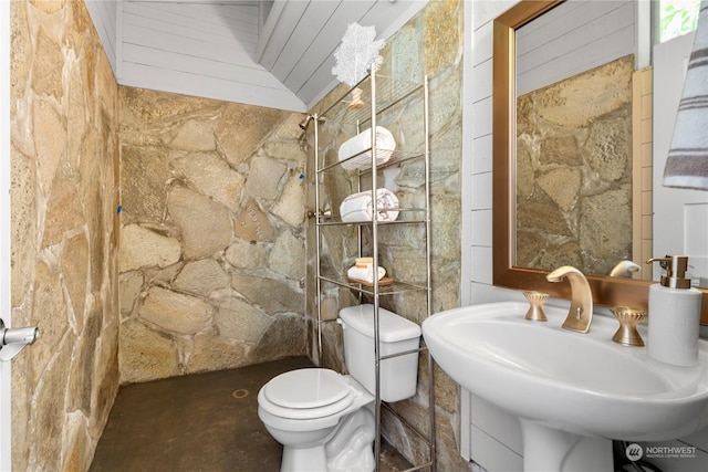 bathroom featuring concrete floors, sink, toilet, and lofted ceiling