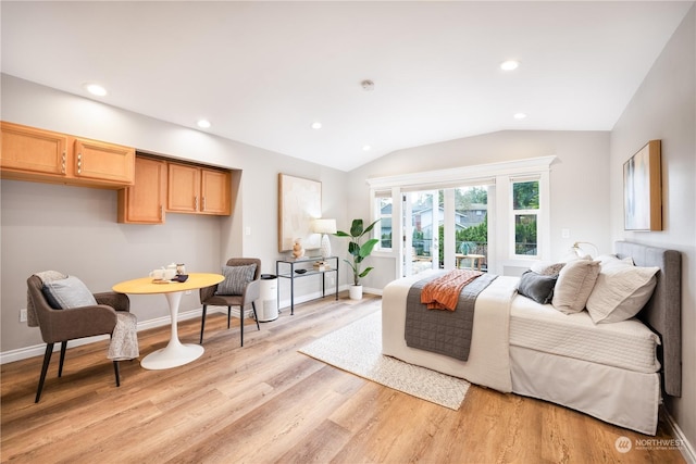 living room with vaulted ceiling and light hardwood / wood-style flooring