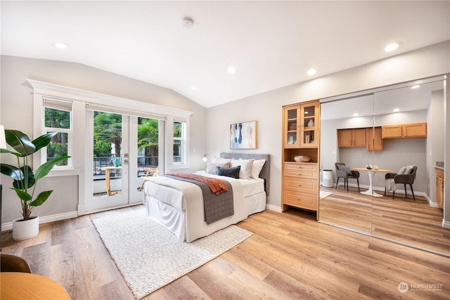 bedroom with light hardwood / wood-style floors, built in desk, french doors, access to outside, and lofted ceiling